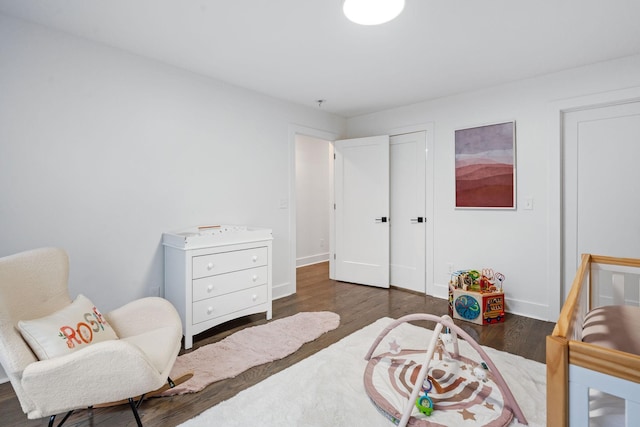 bedroom with dark hardwood / wood-style flooring