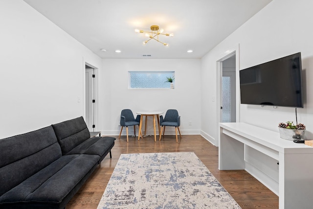 living room with an inviting chandelier and hardwood / wood-style floors