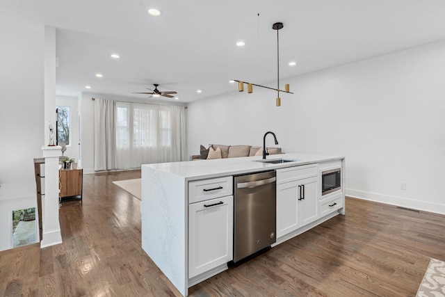 kitchen with stainless steel dishwasher, decorative light fixtures, white cabinetry, ceiling fan, and sink