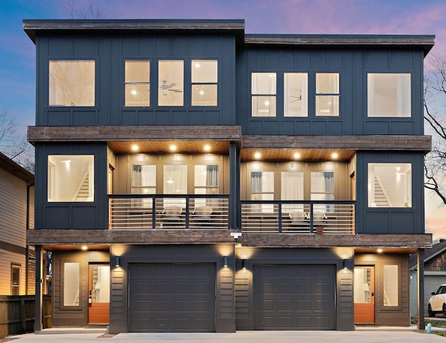 contemporary house featuring a balcony and a garage