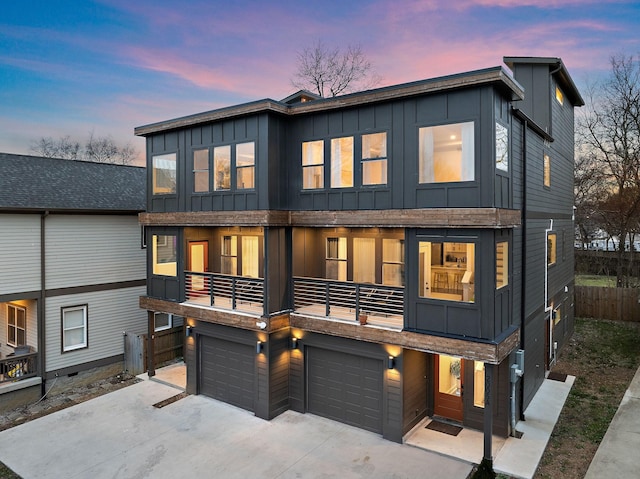 contemporary home with a balcony and a garage