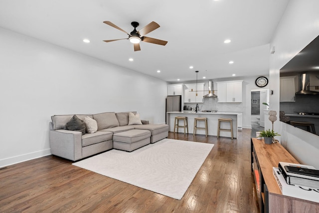 living room featuring dark hardwood / wood-style flooring and ceiling fan