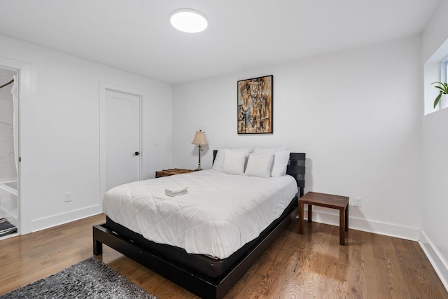 bedroom with hardwood / wood-style floors