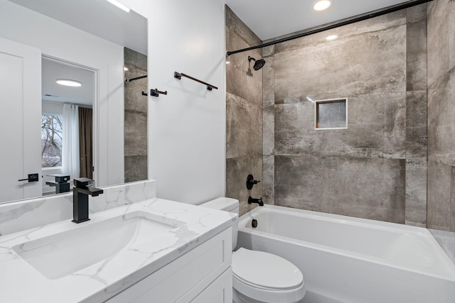 full bathroom with toilet, vanity, and tiled shower / bath combo