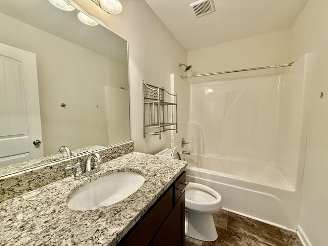 full bathroom with toilet, vanity, and tub / shower combination