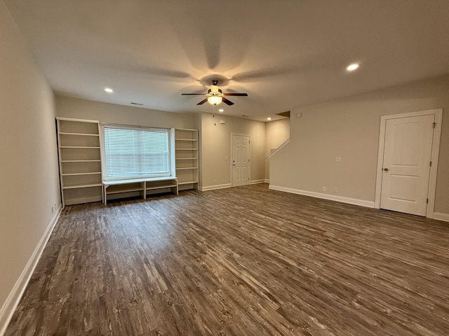 unfurnished living room featuring dark hardwood / wood-style floors and ceiling fan