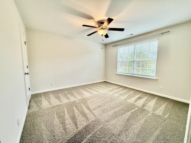 carpeted spare room featuring ceiling fan