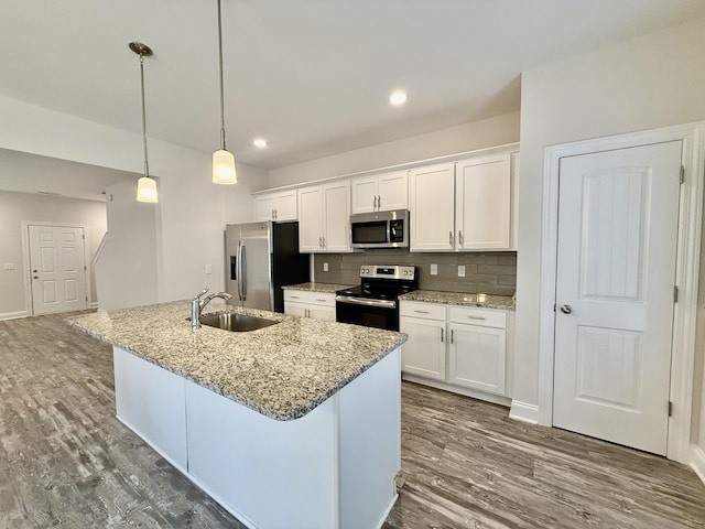 kitchen featuring pendant lighting, sink, white cabinetry, and stainless steel appliances