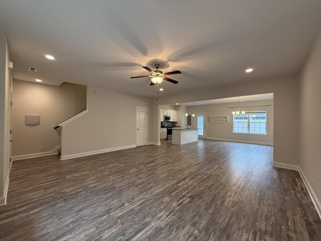 unfurnished living room featuring ceiling fan and dark wood-type flooring