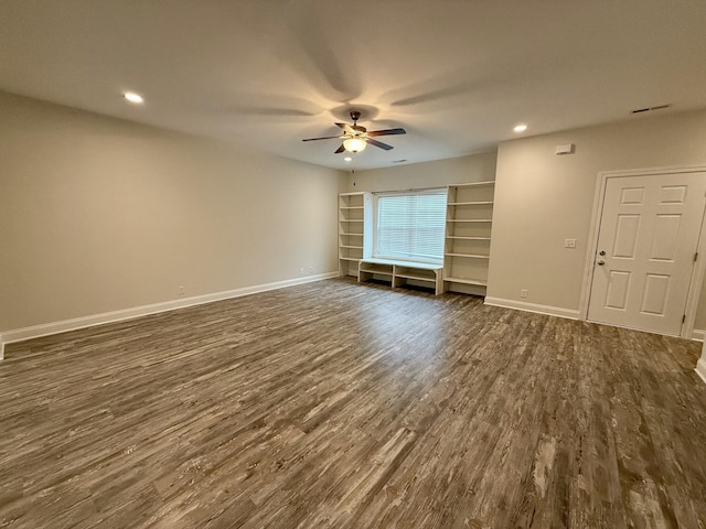 unfurnished room featuring ceiling fan and dark hardwood / wood-style flooring