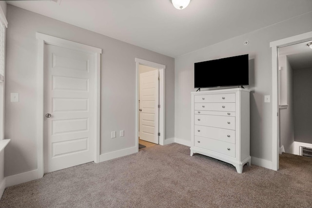 unfurnished bedroom featuring light carpet