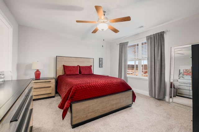 bedroom with ceiling fan and light carpet