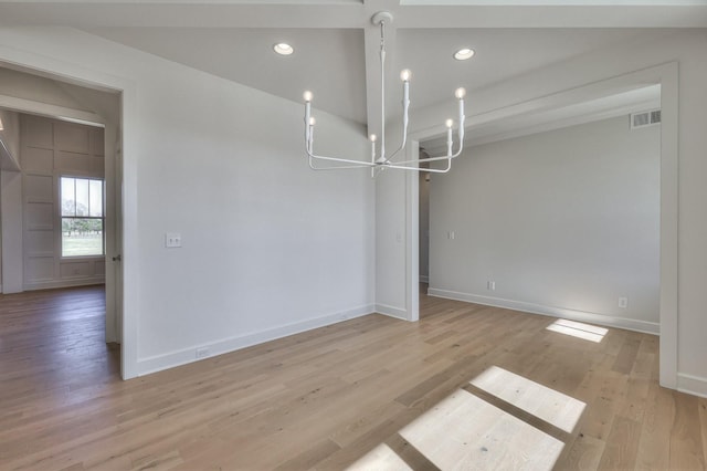 interior space with light hardwood / wood-style floors and an inviting chandelier