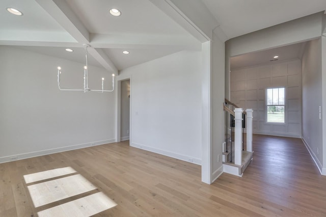 interior space featuring a chandelier, beam ceiling, and light hardwood / wood-style flooring