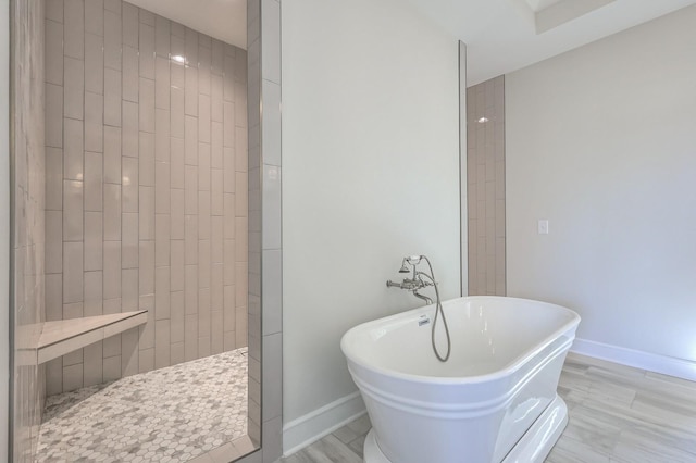 bathroom with wood-type flooring and plus walk in shower