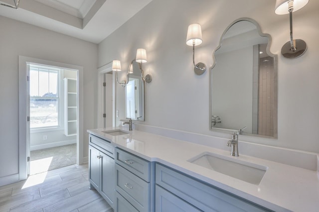 bathroom with crown molding and vanity