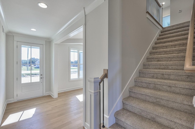 interior space with wood-type flooring and ornamental molding