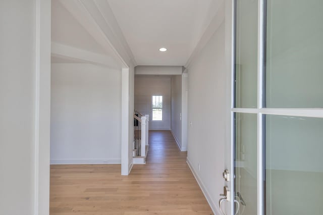 hallway with light hardwood / wood-style floors