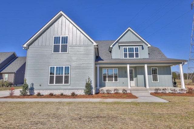 view of front of property with covered porch and a front yard