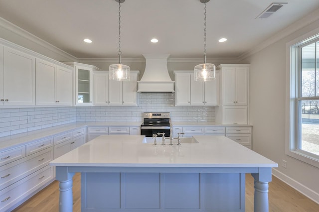 kitchen featuring white cabinetry, stainless steel electric range oven, a breakfast bar area, and custom exhaust hood