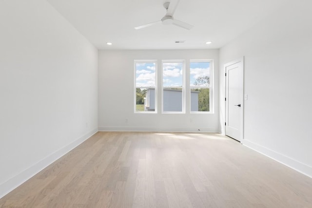 empty room featuring ceiling fan and light hardwood / wood-style floors