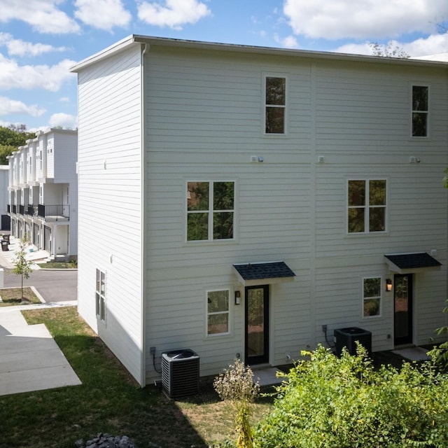 back of house with central AC unit