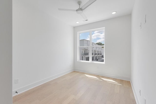 unfurnished room with light wood-type flooring and ceiling fan