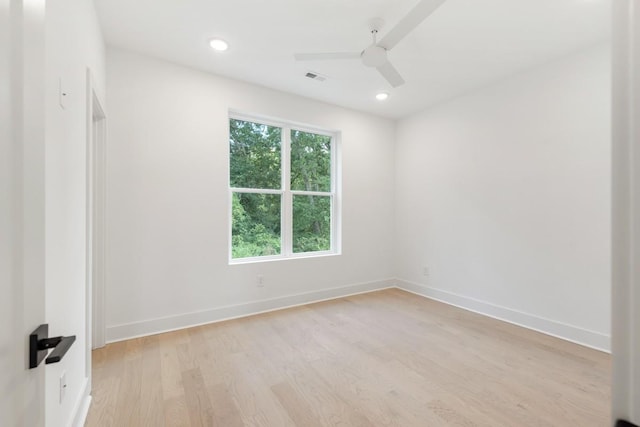 empty room with light hardwood / wood-style flooring and ceiling fan