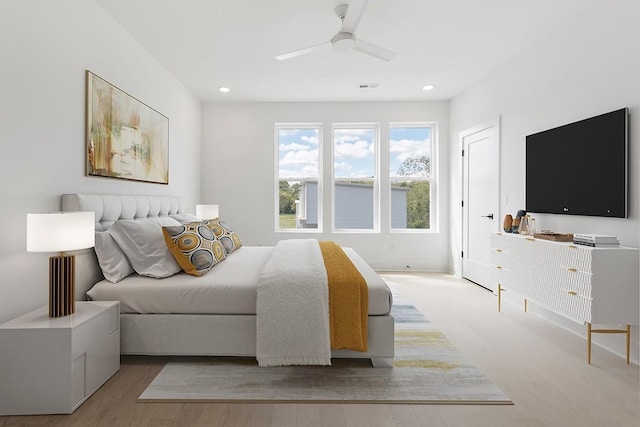 bedroom with ceiling fan and light wood-type flooring