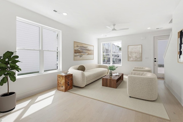 living room featuring light wood-type flooring and ceiling fan