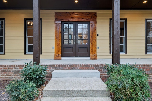 doorway to property featuring french doors and covered porch