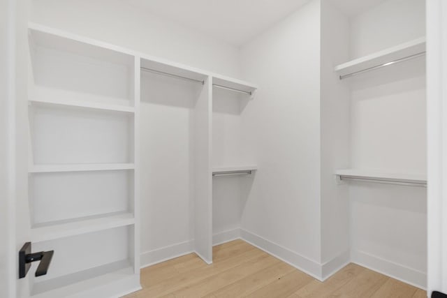 walk in closet with hardwood / wood-style floors