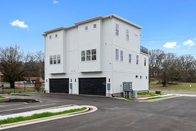 view of home's exterior featuring central AC and a garage