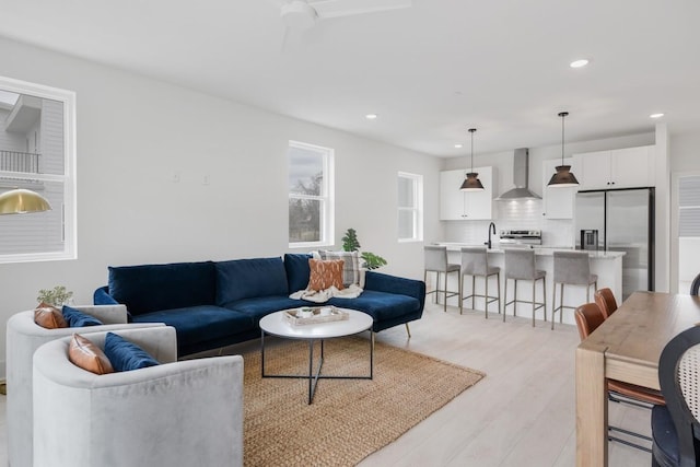 living room with light wood-type flooring and sink