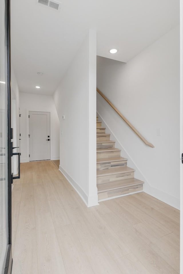 stairs featuring hardwood / wood-style flooring