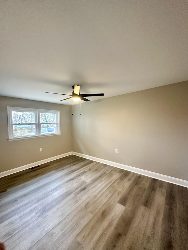 unfurnished room with hardwood / wood-style floors and ceiling fan