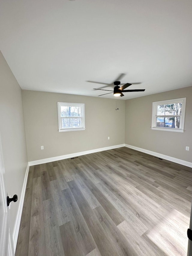 unfurnished room with hardwood / wood-style floors and ceiling fan