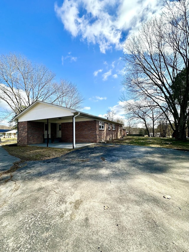 view of home's exterior with a carport