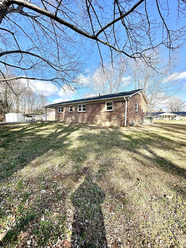 back of property featuring a lawn