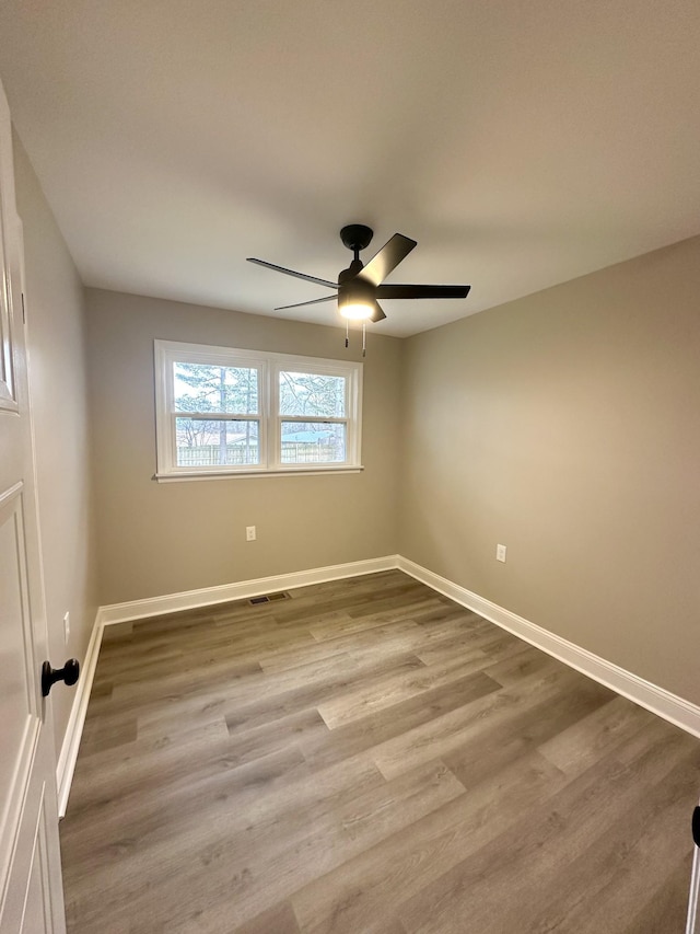 spare room featuring ceiling fan and light wood-type flooring