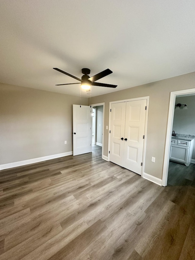 unfurnished bedroom with wood-type flooring and ceiling fan