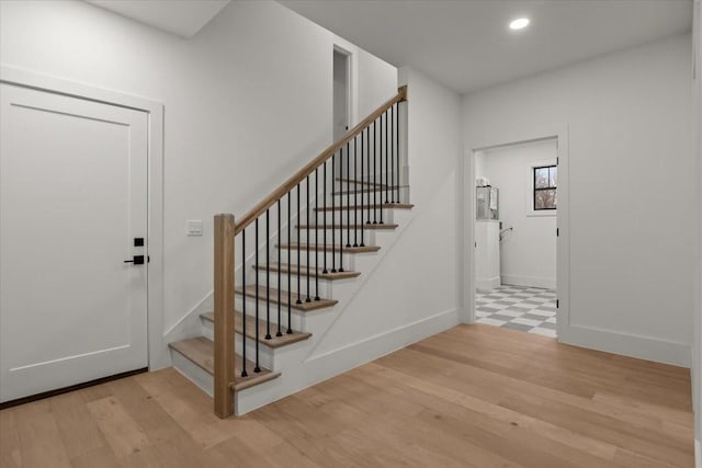 stairs with hardwood / wood-style flooring