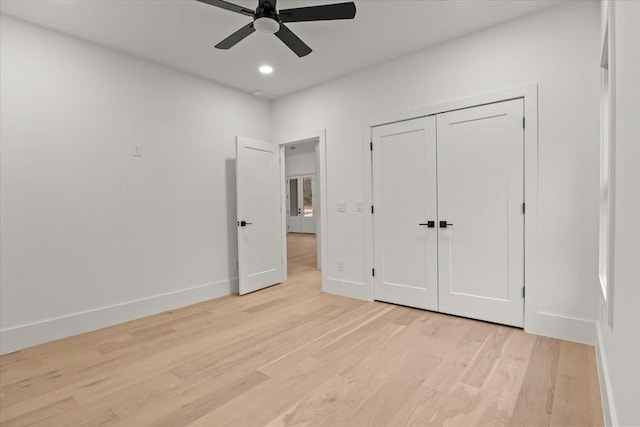 unfurnished bedroom featuring ceiling fan, a closet, and light hardwood / wood-style flooring