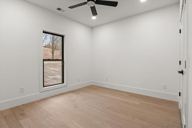 empty room featuring ceiling fan and light hardwood / wood-style floors