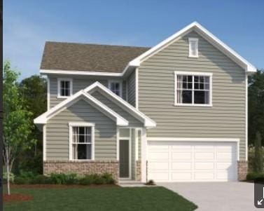 view of front of house featuring a front lawn and a garage