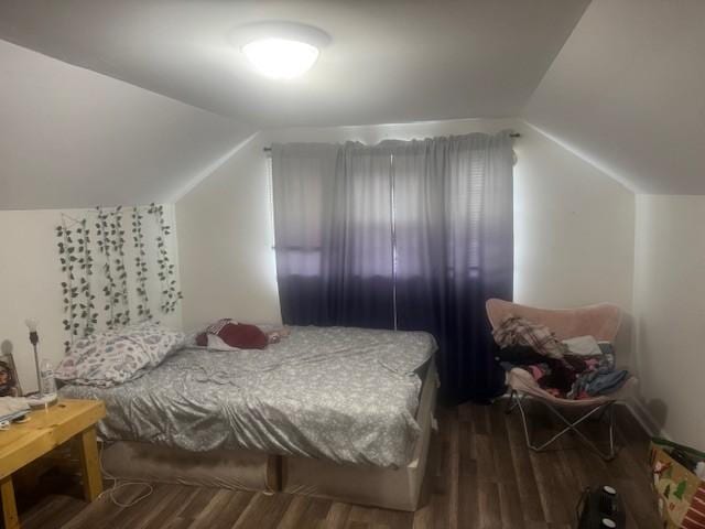 bedroom featuring dark hardwood / wood-style floors and lofted ceiling