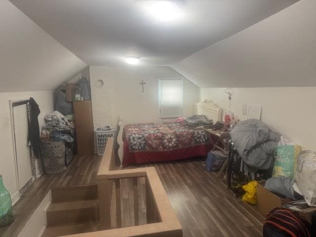 bedroom with vaulted ceiling and dark wood-type flooring