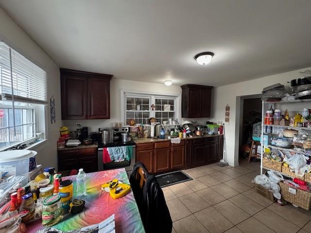 kitchen with light tile patterned floors and sink