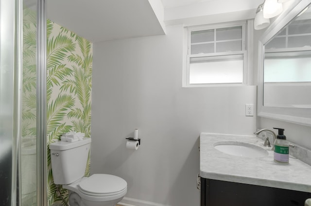 bathroom featuring vanity and toilet