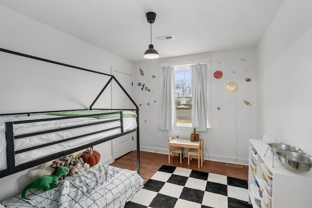 bedroom featuring dark hardwood / wood-style flooring